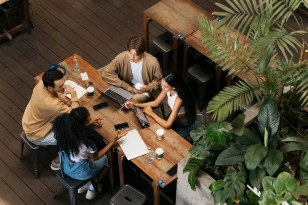 A group in conversation around a cafe table seen from above
