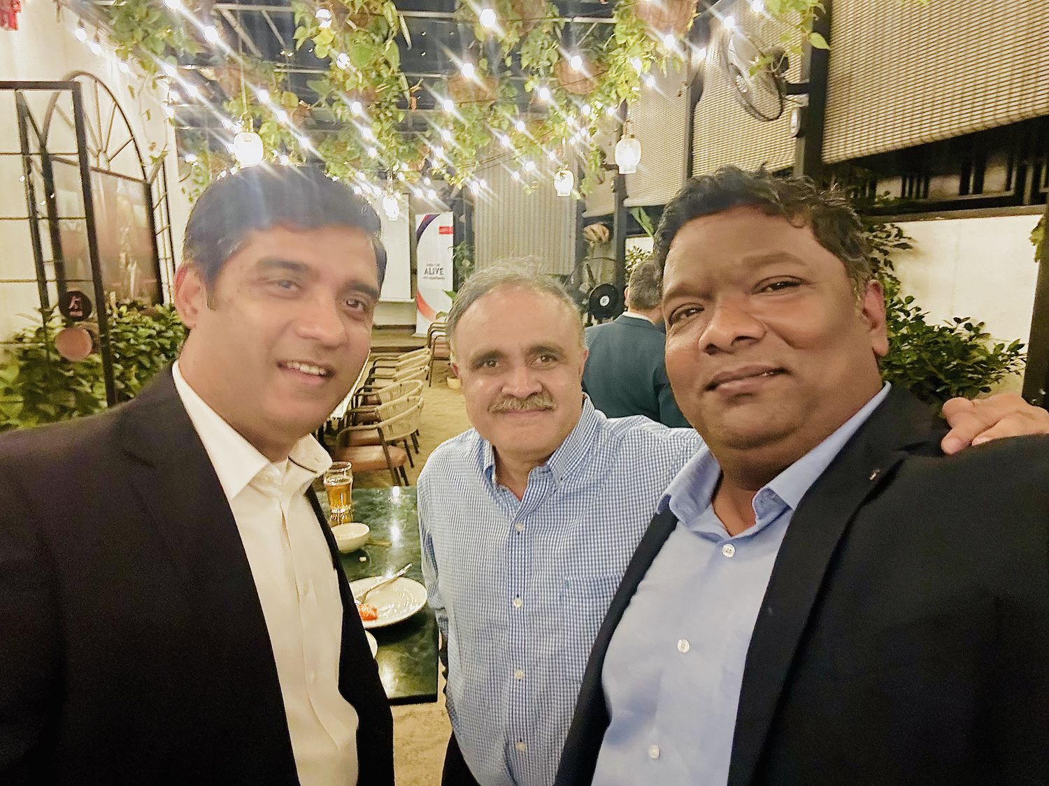 Venkatesh Kumar Pandurengan with two industry leaders at an evening reception