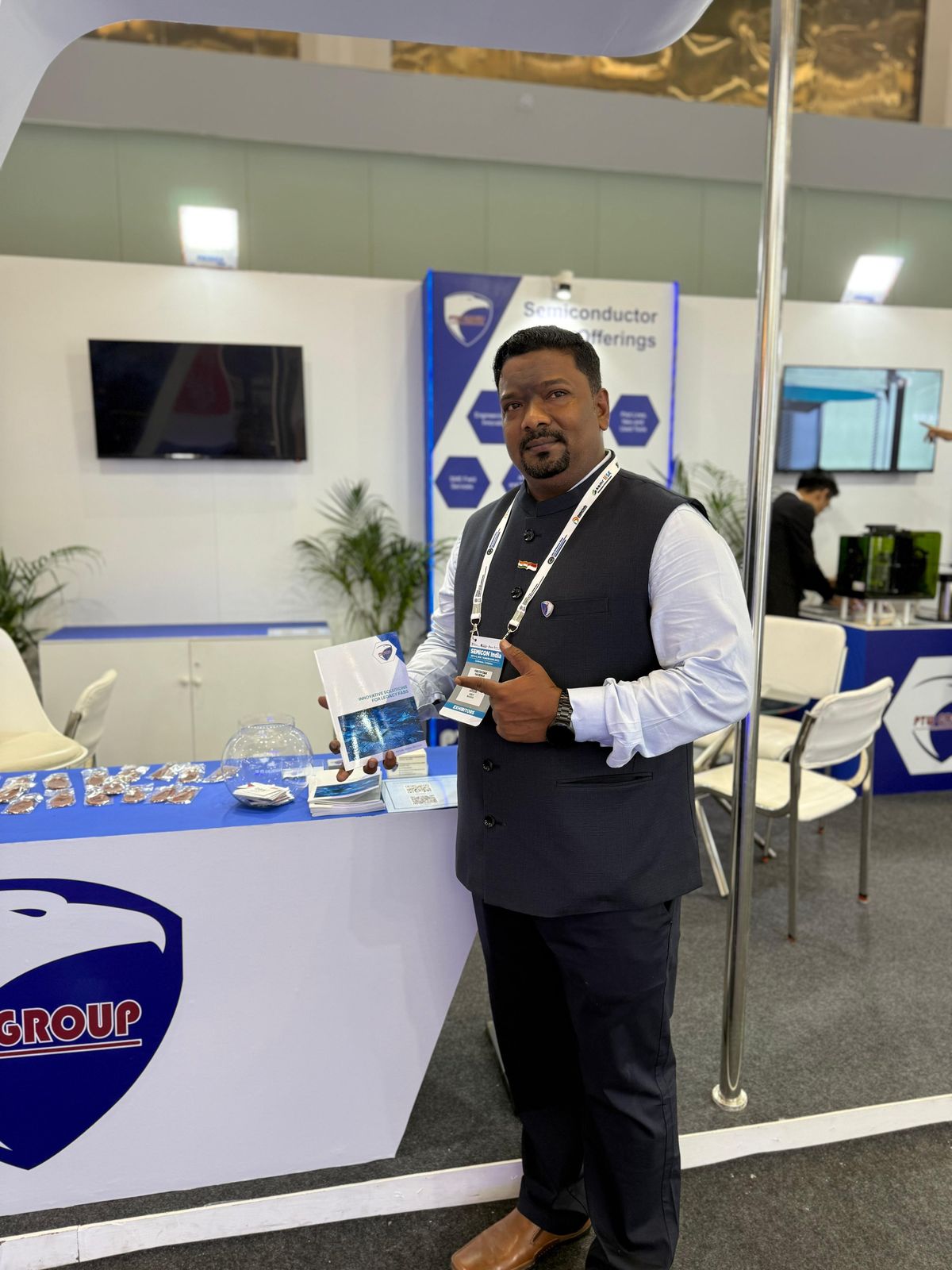Venkatesh Kumar Pandurengan at the PTW Group stand at a semiconductor exhibition