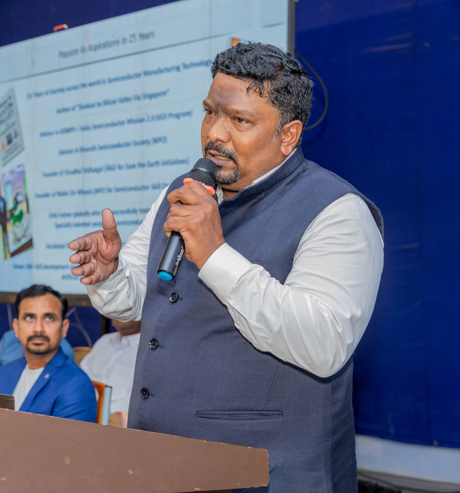 Venkatesh Kumar Pandurengan speaking with a microphone at a semiconductor event